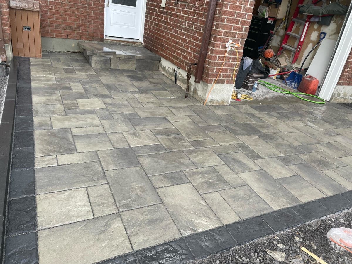 Front entrance interlock landing with natural stone steps